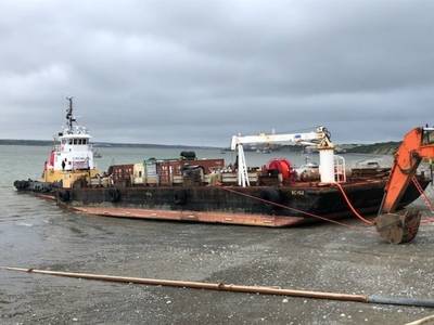 Die Küstenwache reagiert auf ein Treibstoffschiff, das sich im Schlamm niedergelassen hat und beim Abladen von Erdölprodukten auf dem Naknek-Fluss in Naknek am 18. Juni 2019 Anzeichen von strukturellen Belastungen zeigte Für den Fall, dass Kraftstoff ins Wasser gelangt, sind Profis vor Ort. US Coast Guard Foto