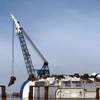 A crane transfers the final lifting lug to be welded to the hull of the Golden Ray in St. Simons Sound, Georgia, June 3, 2020. The 16 lifting lugs will provide connection points for the 255-foot tall Versabar VB 10,0000 crane to fasten to in order to secure sections of the hull as they are cut from the wreck during the Golden Ray’s removal. (Photo: St. Simons Sound Incident Response)