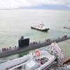 A pair of tug boats pull the Los Angeles-class fast attack submarine USS Santa Fe away from the submarine tender USS Frank Cable after a port visit to Subic Bay, Philippines. Frank Cable conducts maintenance and support of submarines and surface vessels deployed in the U.S. 7th Fleet area of responsibility. (U.S. Navy photo by Petty Officer 1st Class Ricardo Danan)