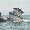 A rescue swimmer assists crewmembers into the water during the Jacqueline A sinking. (Photo: North Myrtle Beach Rescue Squad)