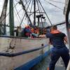Coast Guard Station Port O'Connor boatcrew members assist in transferring a mariner in need of medical attention during a medevac offshore Matagorda Bay near Port O'Connor, Texas, February 23, 2020. The mariner was reported to be in stable condition. (U.S. Coast Guard photo by Station Port O'Connor)