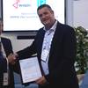 David Barrow, LR Commercial Director â Marine & Offshore presents the AiP to Maarten Spilker, Wison Solutions Director at Gastech this week in Barcelona. (Photo: Lloydâs Register)