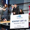 Ships’ sponsor Charlotte Marshall smashing the champagne bottle at the christening ceremony for the future USNS Newport (EPF12) at Austal USA’s shipyard in Mobile, Alabama. (Image: Austal USA)