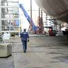 Lt. j.g. Ryan Thomas, a marine Inspector at Coast Guard Sector Delaware Bay, walks below the Kaimana Hila, an 850-foot container ship being constructed in Philadelphia Shipyards, Oct. 4, 2018. The Kaimana Hila and the Daniel K. Inouye are the two largest containerships ever built in the U.S. (Coast Guard photo by Seth Johnson)