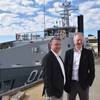 Patrick Gregg (Left) and David Singleton standing in front of a Guardian-class patrol Boat at Austal's Australian shipyard in Henderson, Western Australia. (Photo: Austal)