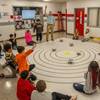 Preston Ailor, an instructional technology teacher for Richmond County Public Schools, leads a fourth grade class through a science unit on solar systems using Lego robots donated by Naval Surface Warfare Dahlgren Division. The donation is part of NSWCDD’s expansive STEM outreach across regional school districts to build a pipeline for the next generation of scientists and engineers essential to the Navy’s mission. (Dorina Watermolen/NSWCDD Photo)