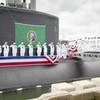 Sailors render a salute during the commissioning ceremony for the Virginia Class Submarine USS Washington (SSN 787) at Naval Station Norfolk. Washington is the U.S. Navy's 14th Virginia-class attack submarine and the fourth U.S. Navy ship named for the State of Washington. (U.S. Navy photo by Class Joshua M. Tolbert)