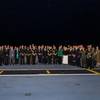 Senior government and military officials from 19 participating nations stand together as part of the Exercise Talisman Sabre 25 Opening Ceremony event onboard HMAS Adelaide, Sydney, New South Wales.