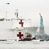 The Capt. Brian A. McAllister leads the way for the USNS COMFORT into NY Harbor as she passes the Statue of Liberty on March 30, 2020. (Photo Credit: Max Guliani)