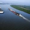 The concept Container on Barge vessel underway on left.
