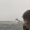 The crew of the Coast Guard Cutter Glenn Harris pulls a person from the water April 13, 2021 after a 175-foot commercial lift boat Seacro Power capsized 8 miles south of Port Fourchon, La. (U.S. Coast Guard photo courtesy of Coast Guard Cutter Glenn Harris)