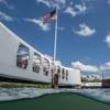 The Flag of the United States of America over the site of the USS Arizona Memorial. The findings underscore the USS Arizona’s dual role as a solemn memorial and a “living laboratory.” (Photo by Brett Seymour, NPS Submerged Resources Center)