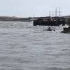 The semi-submerged tugboat Miss Bonnie sits in the water after alliding with the Old Bonner Bridge in Oregon Inlet, North Carolina. (U.S. Coast Guard photo courtesy of Coast Guard Station Oregon Inlet)