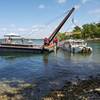 The U.S. Coast Guard oversees the removal of Stretch Duck 7 from Table Rock Lake in Branson, Mo., July 23, 2018. Missouri State Highway Patrol divers rigged the vessel, then a barge crane lifted it to the surface before it was towed to shore and loaded onto a flatbed trailer for transport to a secure facility. (U.S. Coast Guard photo by Lora Ratliff)