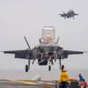 Two F-35B Lightning II fighter aircraft from Marine Fighter Attack Squadron (VMFA) 242, prepare to land on the flight deck of the forward-deployed amphibious assault ship USS America (LHA 6) while conducting flight operations in the Philippine Sea, June 1. America, lead ship of the America Amphibious Ready Group, is operating in the U.S. 7th Fleet area of operations. U.S. 7th Fleet is the U.S. Navy’s largest forward-deployed numbered fleet, and routinely interacts and operates with allies and pa