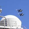 Two F/A-18E Super Hornet, attached to Strike Fighter Squadron (VFA) 151, fly over the Nimitz-class aircraft carrier USS Abraham Lincoln (CVN 72). Abraham Lincoln, flagship of Carrier Strike Group Three, is underway conducting routine operations in the U.S. 7th Fleet area of operations. U.S. 7th Fleet is the U.S. Navy’s largest forward-deployed numbered fleet, and routinely interacts and operates with allies and partners in preserving a free and open Indo-Pacific region. (U.S. Navy photo by Mass 