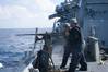 Sailors aboard Arleigh Burke-class guided-missile destroyer USS Curtis Wilbur (DDG 54) fire a M2HB .50-caliber machine gun during a gunnery exercise in the South China Sea. Curtis Wilbur is on patrol in the 7th Fleet area of responsibility in support of security and stability in the Indo-Asia-Pacific region. (U.S. Navy photo by Lt.j.g. Jonathan Peterson/Released)