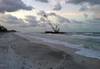A 140-foot barge is shown beached on Long Boat Key, Fla., Wednesday, April 9, 2014. Due to weather conditions, the barge spuds were unable to hold the barge in position and it began drifting until it ran aground on the beach at Long Boat Key. (U.S. Coast Guard photo)