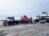 A Dolphin helicopter from Coast Guard Air Station Traverse City, Mich., arrives at Northport Pier in Door County, Wis., on a flatbed trailer March 3, 2014 following a brief ferry transit from Washington Island. (USCG photo)