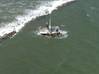 A shrimp boat is grounded on South Galveston Jetty after three fisherman aboard were rescued by the Coast Guard. (U.S. Coast Guard photo by Air Station Houston)