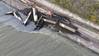 Aerial photo of the derailment of the two locomotives and eight hopper cars. Two additional hopper cars are submerged in the river. (Source: BNSF)​