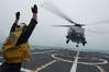 Boatswain's Mate 2nd Class Adam Garnett signals an MH-60R Sea Hawk helicopter from Helicopter Maritime Strike Squadron (HSM) 35 on the flight deck of the littoral combat ship USS Fort Worth (LCS 3). Fort Worth is currently on station conducting helicopter search and recovery operations as part of the Indonesian-led efforts to locate missing AirAsia Flight QZ8501. (U.S. Navy photo by Antonio P. Turretto Ramos)