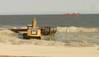 Bulldozers reconstruct the beach and dunes at Long Beach Island, New Jersey, as a dredge ship pumps sand from the Outer Continental Shelf to shore. Photo BOEM