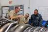 Capt. James S. Talbert, production officer at Norfolk Ship Support Activity, explains the change-out process of an LM2500 gas turbine engine to Rear Adm. Gregorio Martinez Nunez, Director of Mexican Navy General Staff, as Lt. Cmdr. Vargas interprets. (U.S. Navy photo by Art B. Ladle)