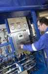 EFC Technician at work on Hydraulic Power Unit (HPU) at EFC Forres manufacturing facility