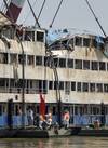 In this photo released by China's Xinhua News Agency, rescuers work in the hull of the upright Eastern Star ship to launch rescue work in the section of Jianli on the Yangtze River, central China's Hubei Province Saturday,