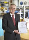 John Ramsden, Managing Director for Sonardyne, with Sonardyne Ltd.’s OHSAS 18001 certification