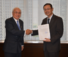 Paraguayan Ambassador to Japan Naoyuki Toyotoshi (left) presents MOL President Koichi Muto with a letter of thanks for the company’s transport of used wheelchairs for disabled children in Paraguay.