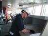 Petty Officer 2nd Class Cody Johnson, a marine inspector stationed at Marine Safety Unit Cleveland, inspects navigation equipment aboard the motor vessel Fortunagract for compliance with international and domestic regulations April 19, 2014. Fortunagracht was the first vessel of its kind to enter the Great Lakes as part of the newly-formed Cleveland-Europe Express. U.S. Coast Guard photo by Lt. Stephanie Pitts