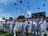 Graduates from USMMA celebrate graduation by tossing covers into the air. The class of 2014 from USMMA included 225 new Merchant Marine and Military Officers. (U.S. Navy photo)