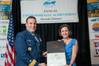 Rear Admiral Joseph Servidio presents Susan Hayman of Foss the award for environmental achievement.