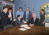 The fifth largest steel producer in the world, South Korea’s POSCO, announced it will build a wire rod processing center at the Port of Indiana-Jeffersonville. Left to right Woon Hyun Yeo, Sales Director, POSCO; Kyu Tae Kim, Finance Director, POSCO; Kenny Hwang (sitting), President, POSCO-AAPC; Rob Waiz, Economic and Re-development Director, City of Jeffersonville; Mike Moore, Mayor, City of Jeffersonville; Scott Stewart, Port Director, Port of Indiana-Jeffersonville; Wendy Dant Chesser, CEO, On