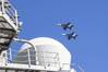 Two F/A-18E Super Hornet, attached to Strike Fighter Squadron (VFA) 151, fly over the Nimitz-class aircraft carrier USS Abraham Lincoln (CVN 72). Abraham Lincoln, flagship of Carrier Strike Group Three, is underway conducting routine operations in the U.S. 7th Fleet area of operations. U.S. 7th Fleet is the U.S. Navy’s largest forward-deployed numbered fleet, and routinely interacts and operates with allies and partners in preserving a free and open Indo-Pacific region. (U.S. Navy photo by Mass 