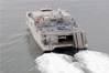 USNS Spearhead with helicopter during sea trials