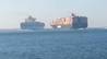 Video screenshot via PoliceInPortsaid of Colombo Express (right) about to collide with Maersk Tanjong in the Suez Canal