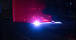 A plasma-burning machine cuts the first steel plat