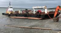 The Coast Guard responds to a fuel barge that settled in the mud and began to show signs of structural stress while offloading petroleum product on the Naknek River in Naknek, June 18, 2019. Coast Guard Marine Safety Task Force responders from Sector Anchorage and contracted cleanup professionals are standing by on site in the event that any fuel enters the water. U.S. Coast Guard photo