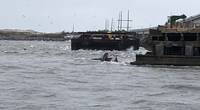 The semi-submerged tugboat Miss Bonnie sits in the water after alliding with the Old Bonner Bridge in Oregon Inlet, North Carolina. (U.S. Coast Guard photo courtesy of Coast Guard Station Oregon Inlet)