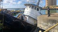Coast Guard pollution response personnel from Resident Inspection Office St Croix assess the pollution threat from the partially sunken tugboat Cape Lookout Nov. 13, 2020, which partially sank at the St. Croix Renaissance Group facility within Krause Lagoon in St. Croix, U.S. Virgin Islands. (U.S. Coast Guard photos)