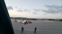 A U.S. Coast Guard helicopter crew walks an ailing mariner to an aircraft in Providenciales, Turks and Caicos, on Wednesday. The man was experiencing health complications aboard the tug Patriarch and needed higher level medical care. (U.S. Coast Guard photo)