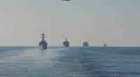 The guided-missile destroyer USS Mitscher (DDG 57), left, the dry cargo and ammunition ship USNS Charles Drew (T-AKE 10), the fleet replenishment oiler USNS Guadalupe (T-AO 300), and the guided-missile cruiser USS Mobile Bay (CG 53) transit the Strait of Hormuz, Dec. 21, 2018. The John C. Stennis Carrier Strike Group is deployed to the U.S. 5th Fleet area of operations in support of naval operations to ensure maritime stability and security in the Central Region, connecting the Mediterranean and