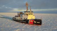 File photo: The US Coast Guard Cutter Katmai Bay, a 140-foot ice-breaking tug, escorts a motor vessel through Lake Michigan near Lansing Shoal, in 2014. The cutter was operating as part of Operation Taconite, which is the icebreaking operation for the northern Great Lakes. (U.S. Coast Guard photo by Daniel R. Michelson)