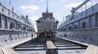 A dive boat attached to Mid-Atlantic Regional Maintenance Center (MARMC) Dive Locker sits on the blocks of MARMC’s floating dry dock Dynamic (AFDL 6) for repairs. (Photo: Hendrick L. Dickson / U.S. Navy).