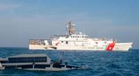 An Ocean Aero Triton unmanned surface vessel operates alongside U.S. Coast Guard fast response cutter USCGC Emlen Tunnell (WPC 1145) in the Arabian Gulf, November 29, during Digital Horizon 2022. (Credit: Brandon Murphy / U.S. Army)