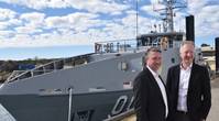 Patrick Gregg (Left) and David Singleton standing in front of a Guardian-class patrol Boat at Austal's Australian shipyard in Henderson, Western Australia. (Photo: Austal)