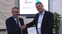 David Barrow, LR Commercial Director – Marine & Offshore presents the AiP to Maarten Spilker, Wison Solutions Director at Gastech this week in Barcelona. (Photo: Lloyd’s Register)